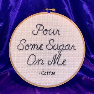 Hand stitched coffee says “pour some sugar on me”